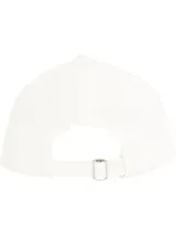 Gorra blanca de algodón con logo Tommy Jeans bordado en negro en el frente.