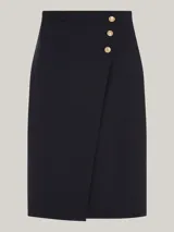 Falda midi cruzada color azul marino, con tres botones dorados con el escudo de la marca en la parte superior.
