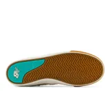 Zapatillas de skate New Balance Numeric modelo 306, color beige con detalles en turquesa, blanco y marrón. Confeccionadas en gamuza y material sintético, con logo "N" en los laterales y suela de goma.