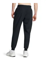 Pantalón deportivo Under Armour Unstoppable para hombre, color negro, de corte ajustado con puños elásticos en los tobillos y bolsillos laterales con cierre.