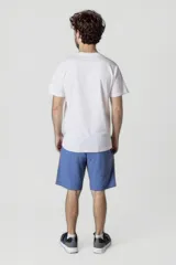 Remera blanca de manga corta con estampado frontal que dice 'Columbia New York Est. 1754' en color verde.
