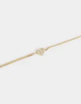 Pulsera dorada de cadena cola de ratón con dije de corazón adornado con strass y cierre de mosquetón.