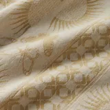 Camisa de manga corta color beige con estampado de mariposas y soles.