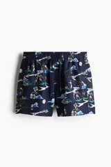 Short de baño azul marino con estampado de motivos playeros, cintura elastizada con cordón de ajuste, bolsillos laterales y bolsillo trasero con velcro.