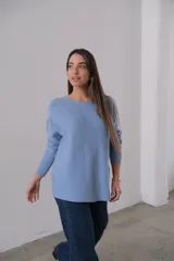 Sweater celeste de punto con corte recto y cuello redondo. Presenta detalle de líneas verticales formadas con el mismo hilado en la parte delantera.