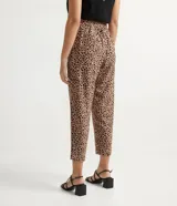 Pantalón fluido con estampado de leopardo, cintura elástica con lazo ajustable, bolsillos laterales y cierre con botón.
