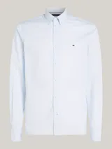 Camisa celeste de corte slim fit con microestampado, cuello abotonado, mangas largas con puños redondeados y logo de Tommy Hilfiger bordado en el pecho.