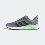 Championes de entrenamiento Adidas Dropset Control, color gris con detalles en negro y verde. Presentan ajuste ancho, mediasuela estable y sistema de torsión de TPU en el mediopié. El exterior es de tejido de malla.