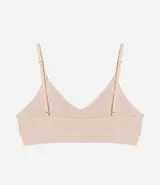 Soutien top color piel, confeccionado en poliamida con acabado seamless, breteles ajustables y superficie texturizada.