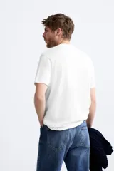 Jersey de punto color marrón oscuro, de corte relajado (relaxed fit), con cuello redondo y manga corta.