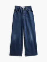 Pantalón de jean azul de pierna ancha y talle alto, con efecto desteñido y usado.