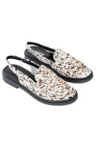 Zuecos destalonados con estampado animal print en tonos marrones y blancos, con detalle de antifaz y suela plana color negro.