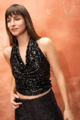 Musculosa negra de lentejuelas con escote halter y espalda descubierta.