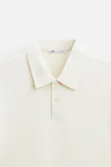 Polo verde oliva de tejido piqué, corte regular fit, cuello solapa con cierre frontal de botonadura y manga corta.