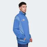 Buzo azul con medio cierre, cuello alto y escudo del Club Nacional de Football bordado en el pecho.