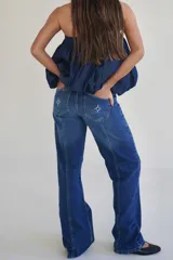 Pantalón de jean gris oscuro de corte recto, tiro medio y largo. Diseño con costuras verticales y lavado con sobreteñido.