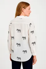 Camisa blanca con estampado de cebras negras, de corte holgado y manga larga.
