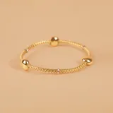 Pulsera de oro amarillo y blanco 18k con esferas y malla extensible.