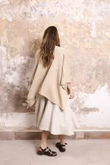 Saco tipo poncho color salmón, tejido en algodón, de silueta oversize y mangas 3/4 caídas.