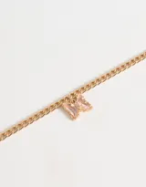 Pulsera dorada con dije de mariposa con incrustaciones de cristal rosado.