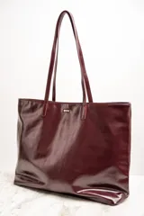 Bolso tipo tote grande color bordó, de cuero vegano, con doble asa corta.