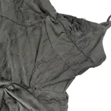 Minivestido negro con breteles finos, escote en V y corte asimétrico con volados y lazos.